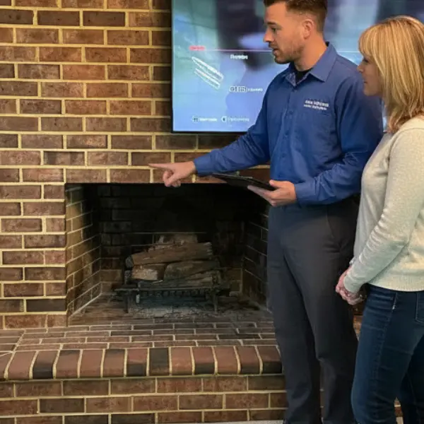 NFI Certified Gas Specialist discussing direct vent fireplace insert installation with a homeowner