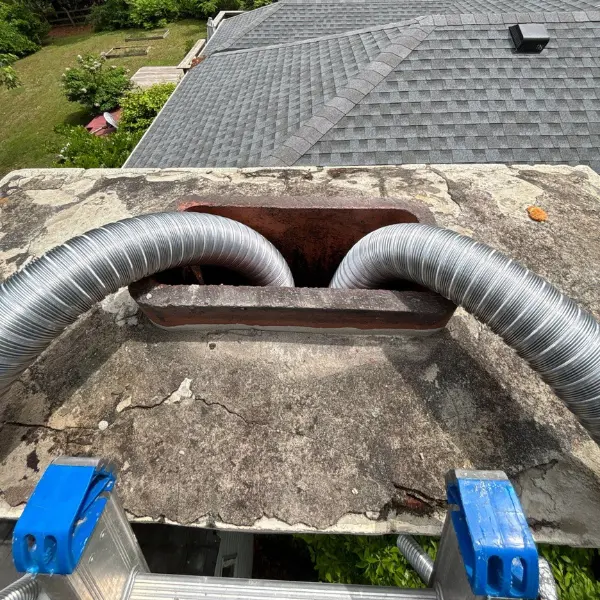 Direct vent fireplace insert vent liners being installed inside a masonry chimney