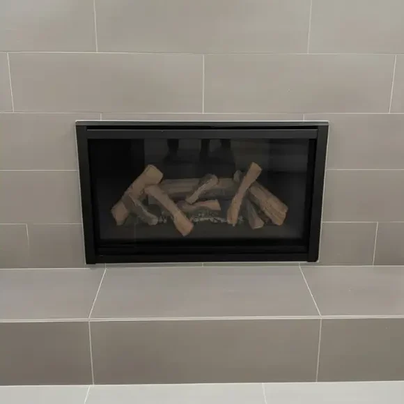 Modern direct vent fireplace insert with custom tile surround